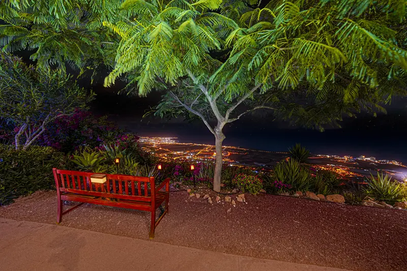 Garden bench with coastal night views at Villa Monaco Adeje Tenerife