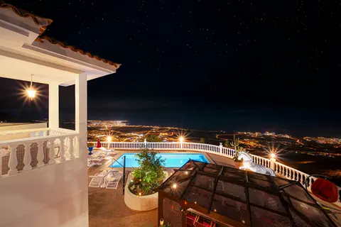 Glamour bedroom balcony view at night overlooking the pool at Villa Monaco Adeje Tenerife Glamour bedroom balcony view at night overlooking the pool at Villa Monaco Adeje Tenerife