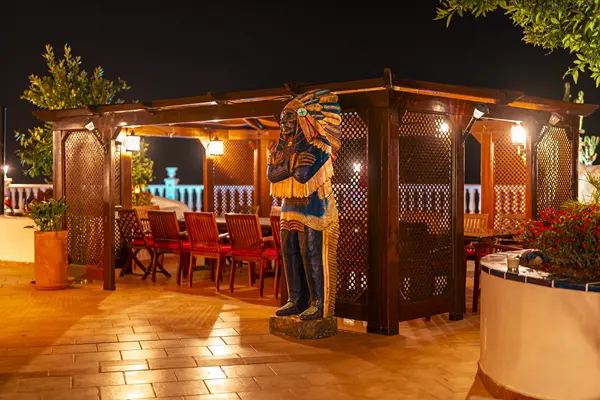 Covered outdoor dining terrace with evening lighting and barbecues at Villa Monaco Adeje Tenerife